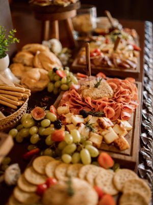 Elegant charcuterie board with cheese, fruit, and meats, perfect for weddings.