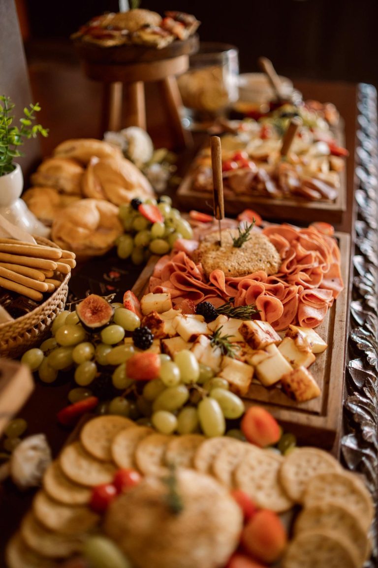 Elegant charcuterie board with cheese, fruit, and meats, perfect for weddings.
